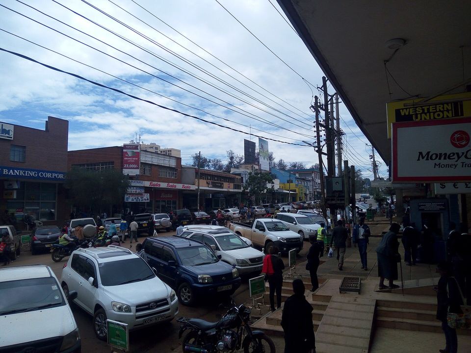 Shops and matatus on a street in Eldoret town centre