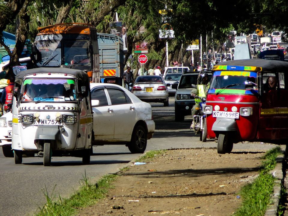 Tuk-tuks and shops on a busy Nakuru street