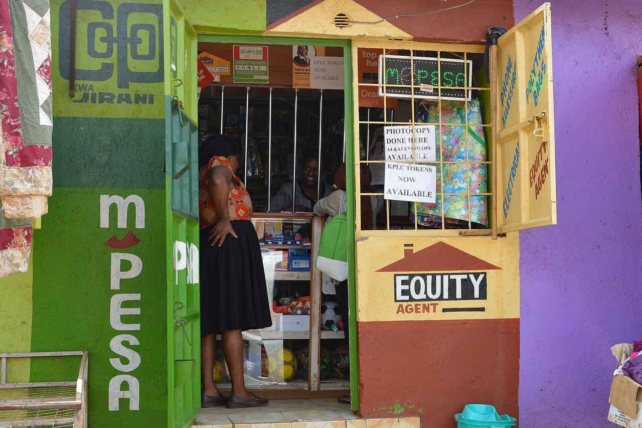 A member paying into the Sacco at an M-Pesa agent kiosk